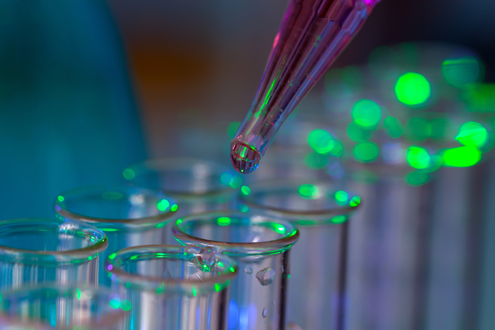 Pipette adding fluid to one of several test tubes